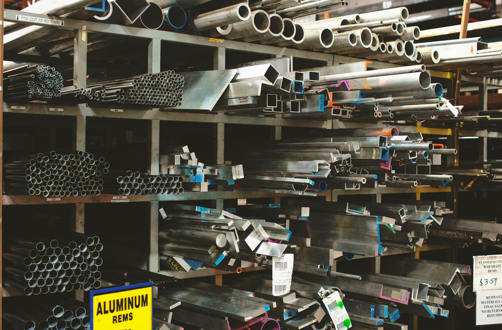 A rack of different types of aluminum tubing
