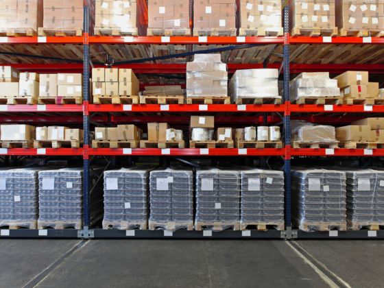 Warehouse shelves stocked with pallets of goods