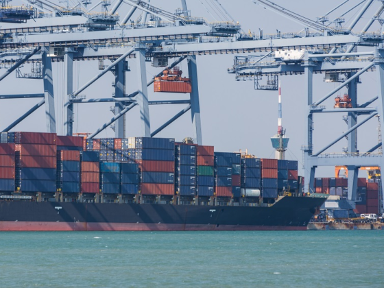 Large dock cranes unloading a large cargo ship