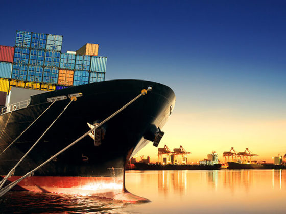 Bow of docked cargo ship at dusk