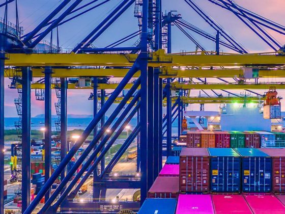 Container ship in deep sea port at night