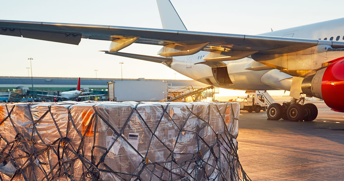 Cargo waiting to be loaded on cargo plane in the background