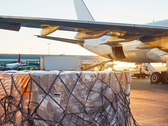 Cargo waiting to be loaded on cargo plane in the background