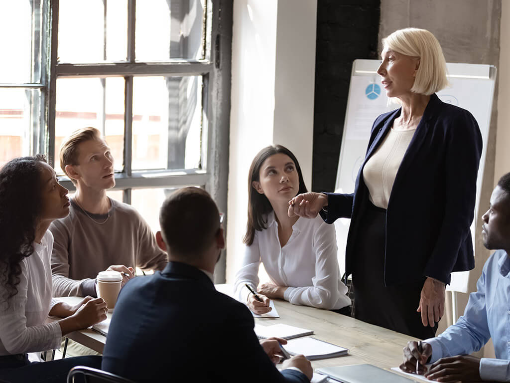 Business woman speaking to young new hires